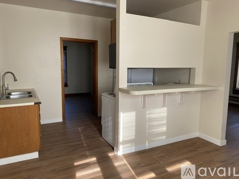 A kitchen with a sink and a counter.