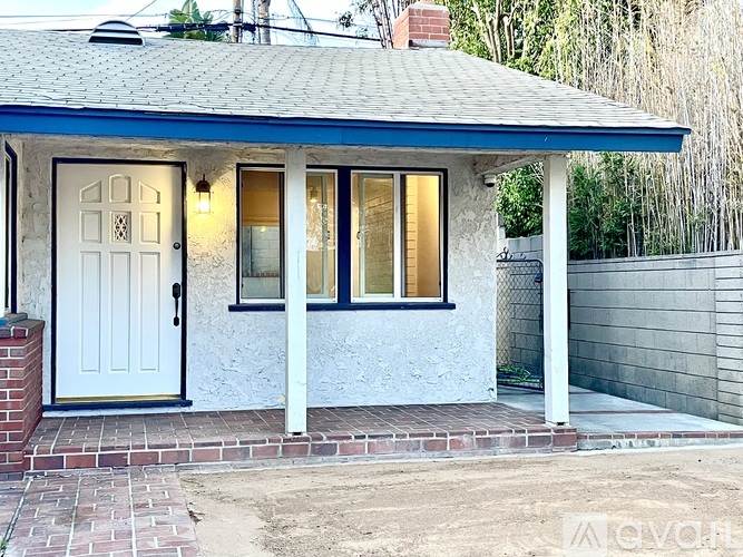 A small house with a white door and windows.