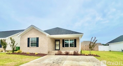 A house with a front yard and a driveway.
