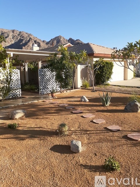 A house with a garden in front of it.