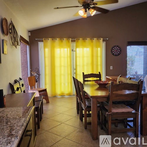 A dining room with a table set for six.