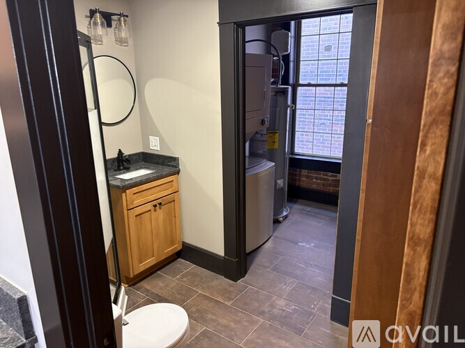 A bathroom with a toilet, sink, and a shower stall.