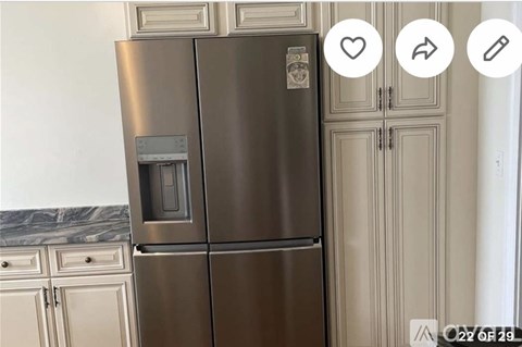A stainless steel refrigerator with a water and ice dispenser in the middle of the door.