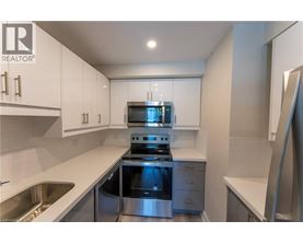 A modern kitchen with stainless steel appliances and white cabinets.