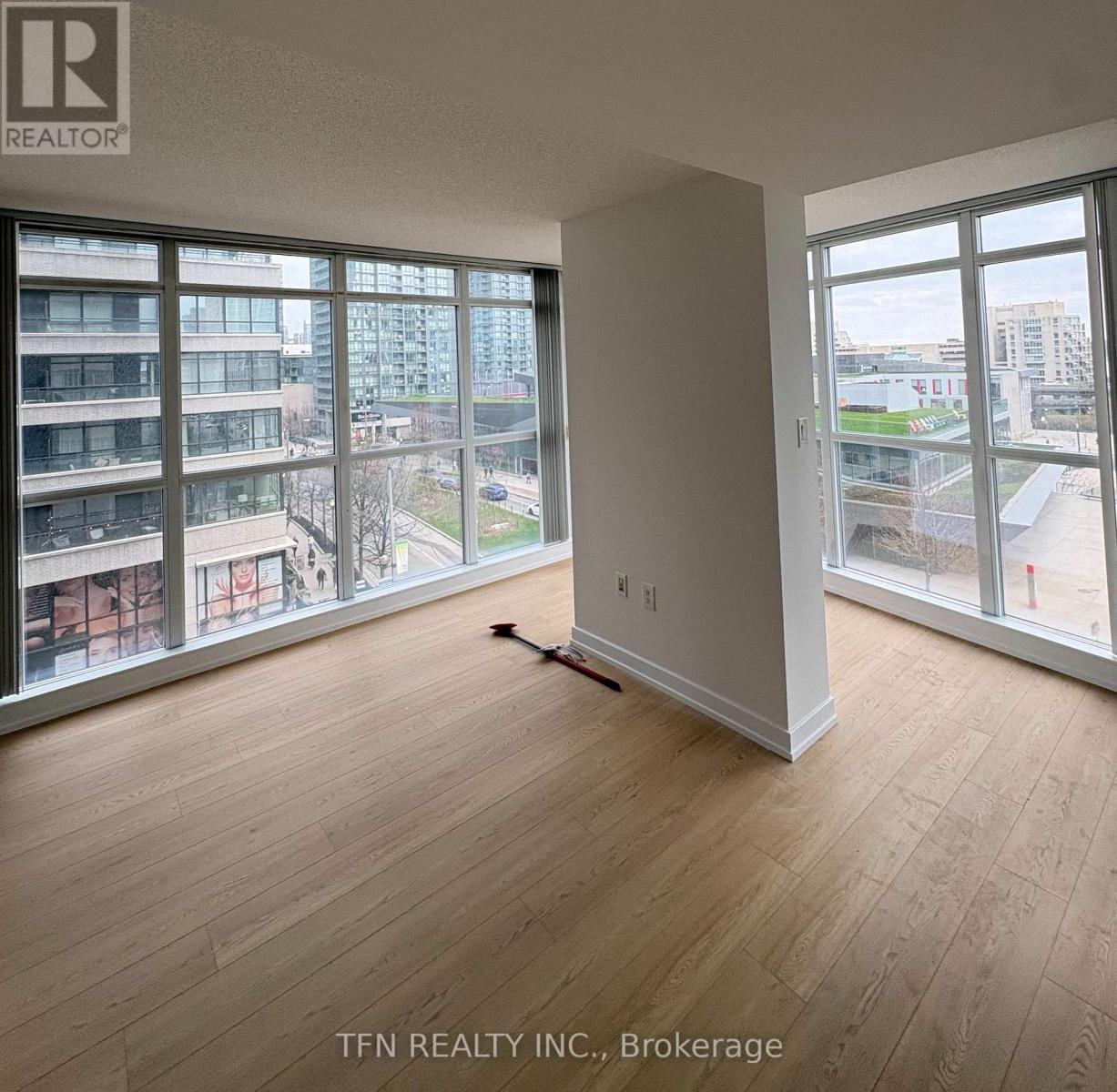A room with a brokerage sign on the wall.