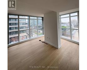 A room with a brokerage sign on the wall.