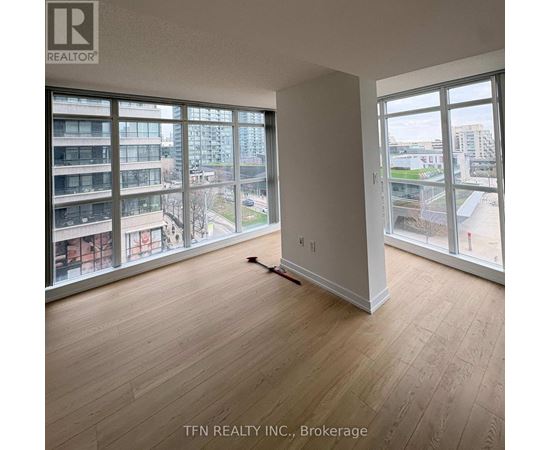A room with a brokerage sign on the wall.