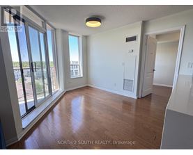 A room with a sliding glass door leading to a balcony.