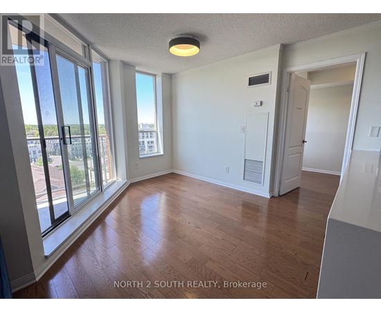 A room with a sliding glass door leading to a balcony.