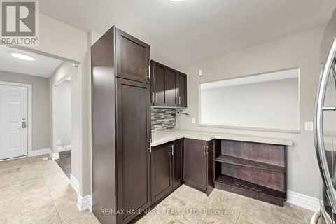 A kitchen pantry with a large cabinet and a white wall.