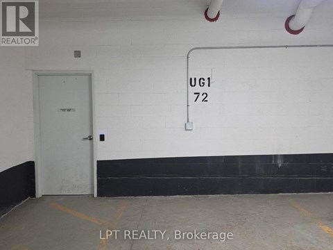 A white door with a sign that says UG1 72 on the wall.