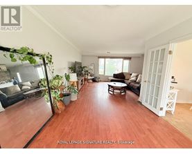 A living room with wooden floors and furniture.