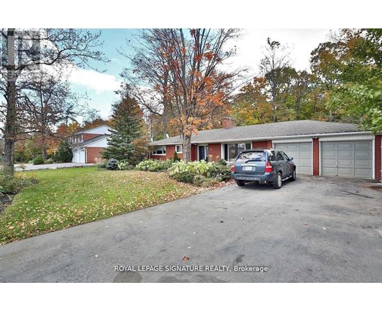 A Royal LePage Signature Realty Brokerage sign is in front of a house.