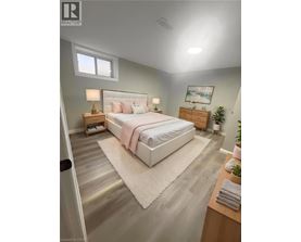 A bedroom with a large bed, a nightstand, and a small plant.