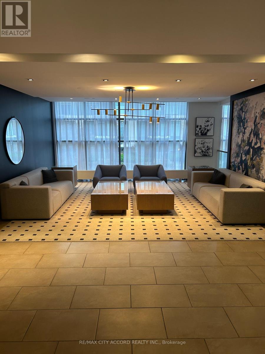 A living room with a large window and a patterned floor.