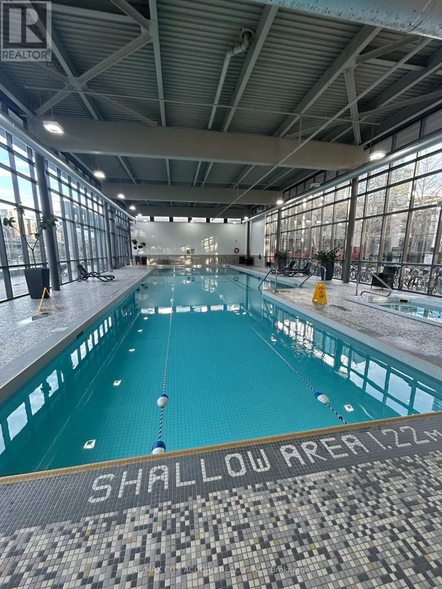 A large indoor swimming pool with the words "SHALLOW AREA 1.22" written on the bottom.