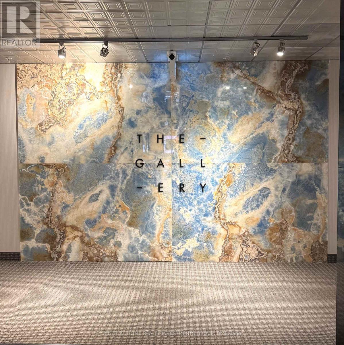 A wall with a map design and the words "The Gallery" written on it.