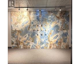 A wall with a map design and the words "The Gallery" written on it.