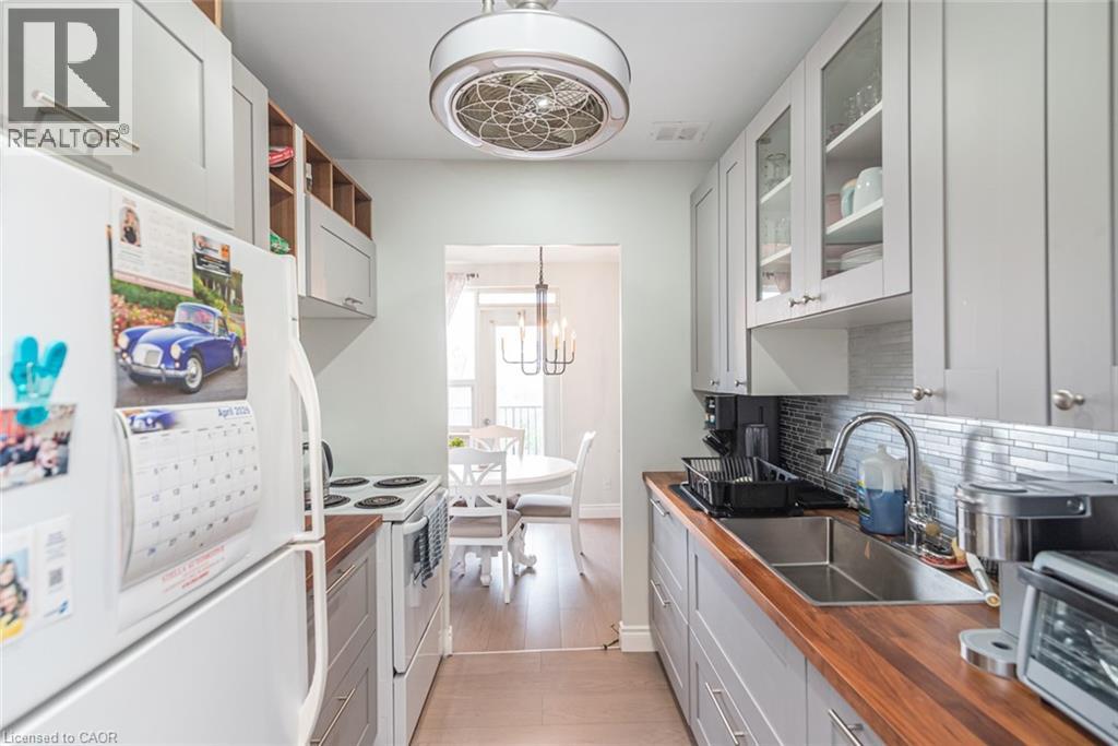 A kitchen with white cabinets and a white fridge.