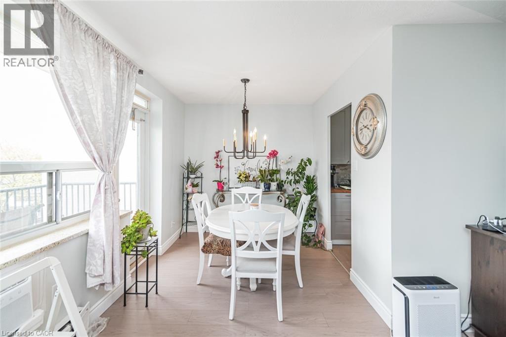 A dining room with a white table and chairs.