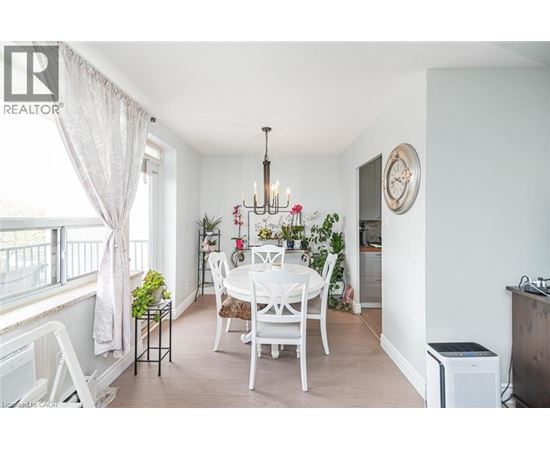 A dining room with a white table and chairs.