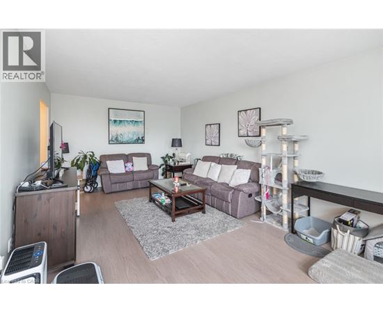 A living room with a grey couch and a wooden coffee table.