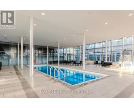 A large indoor swimming pool with a glass wall and a caption that reads "EXP REALTY, Brokerage".