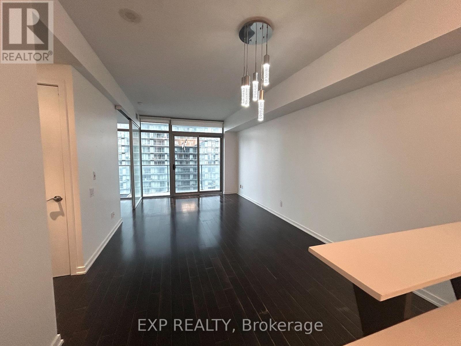 A room with a long table and a door leading to a balcony.