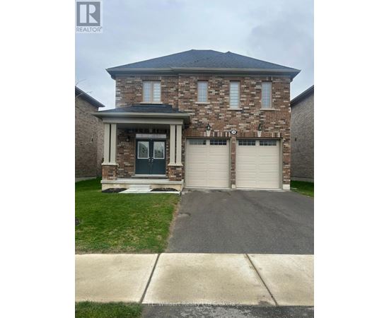 A house with a garage door and a driveway in front.