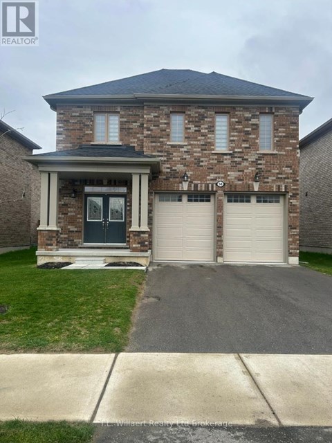 A house with a garage door and a driveway in front.