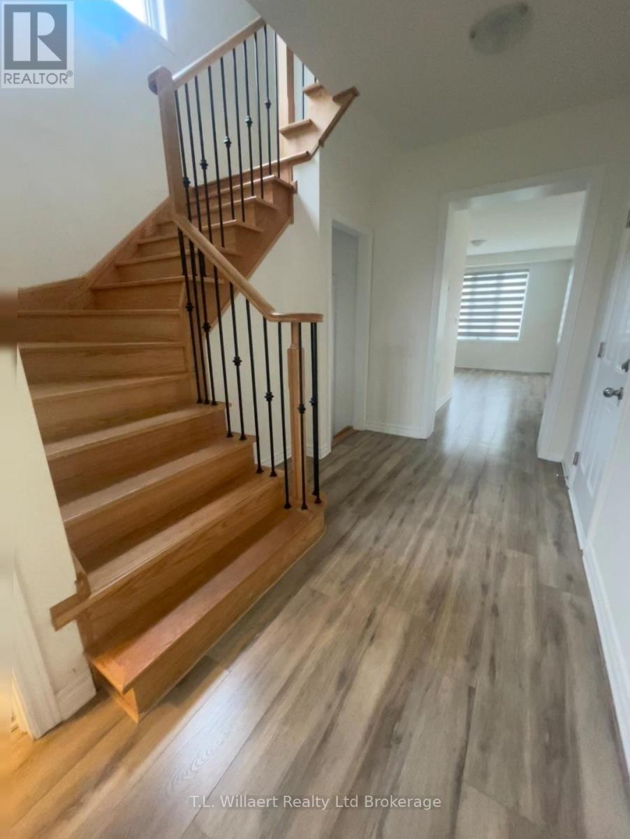 A wooden staircase with a metal railing.