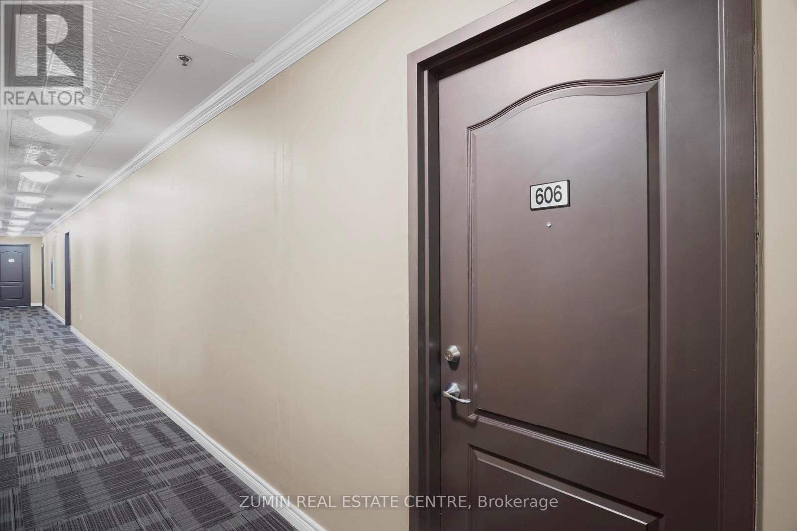 A hallway with a door numbered 606.