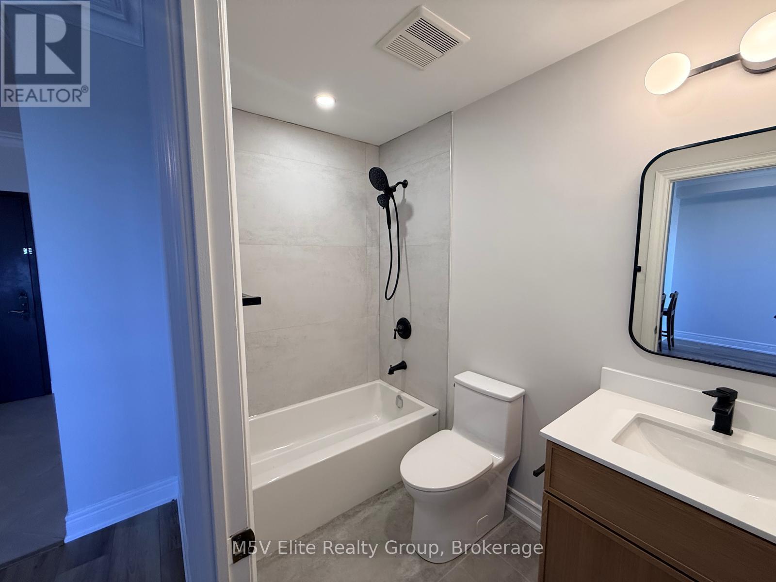A bathroom with a toilet, sink, and bathtub.