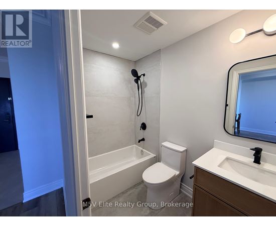 A bathroom with a toilet, sink, and bathtub.