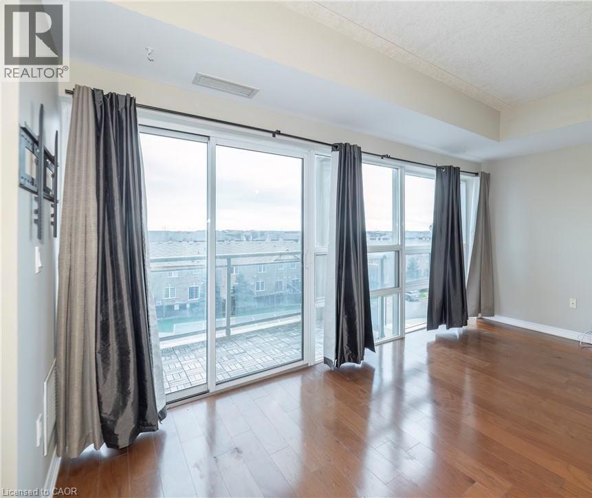 A room with a sliding glass door and a view of the city.