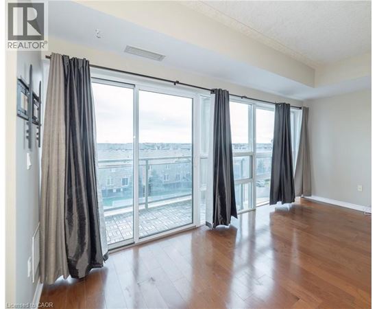 A room with a sliding glass door and a view of the city.