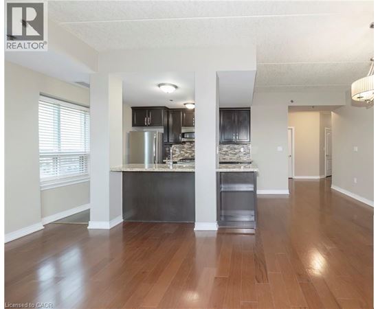 A spacious kitchen with wood floors and a center island.