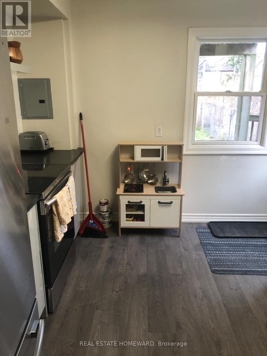 A kitchen with a black counter top and a white cabinet.