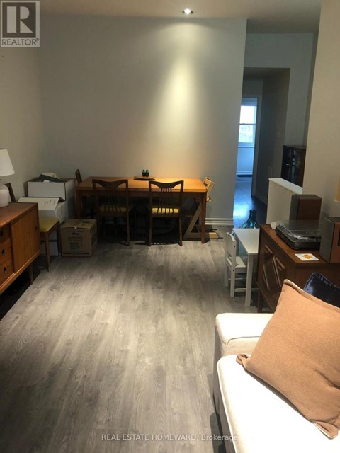 A living room with a couch and a dining table.