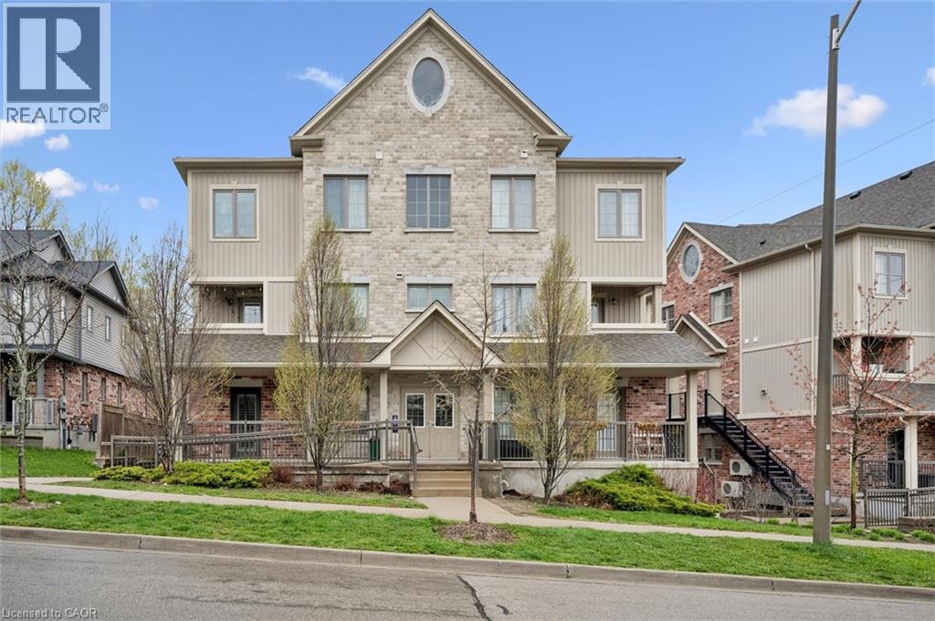 A large house with a stone facade is for sale.
