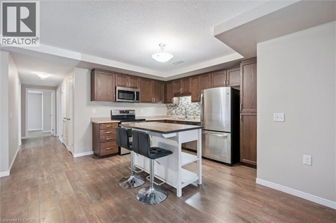 A kitchen with a table and chairs in the middle of the room.