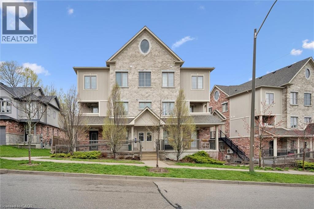 A large, two-story residential building with a mix of brick and siding exterior.