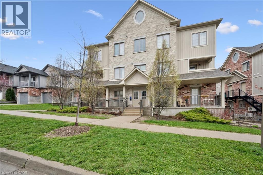 A large two-story house with a well-maintained lawn in front.