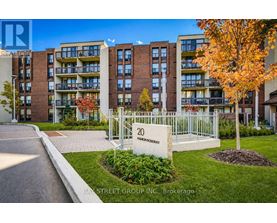 A street view of a residential area with apartment buildings and a sign that reads "20 BAY STREET GROUP INC. Brokerage".