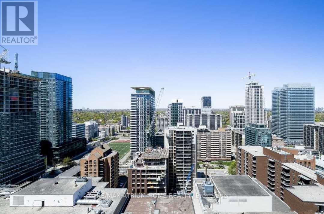 A cityscape with a clear blue sky and buildings of various heights.