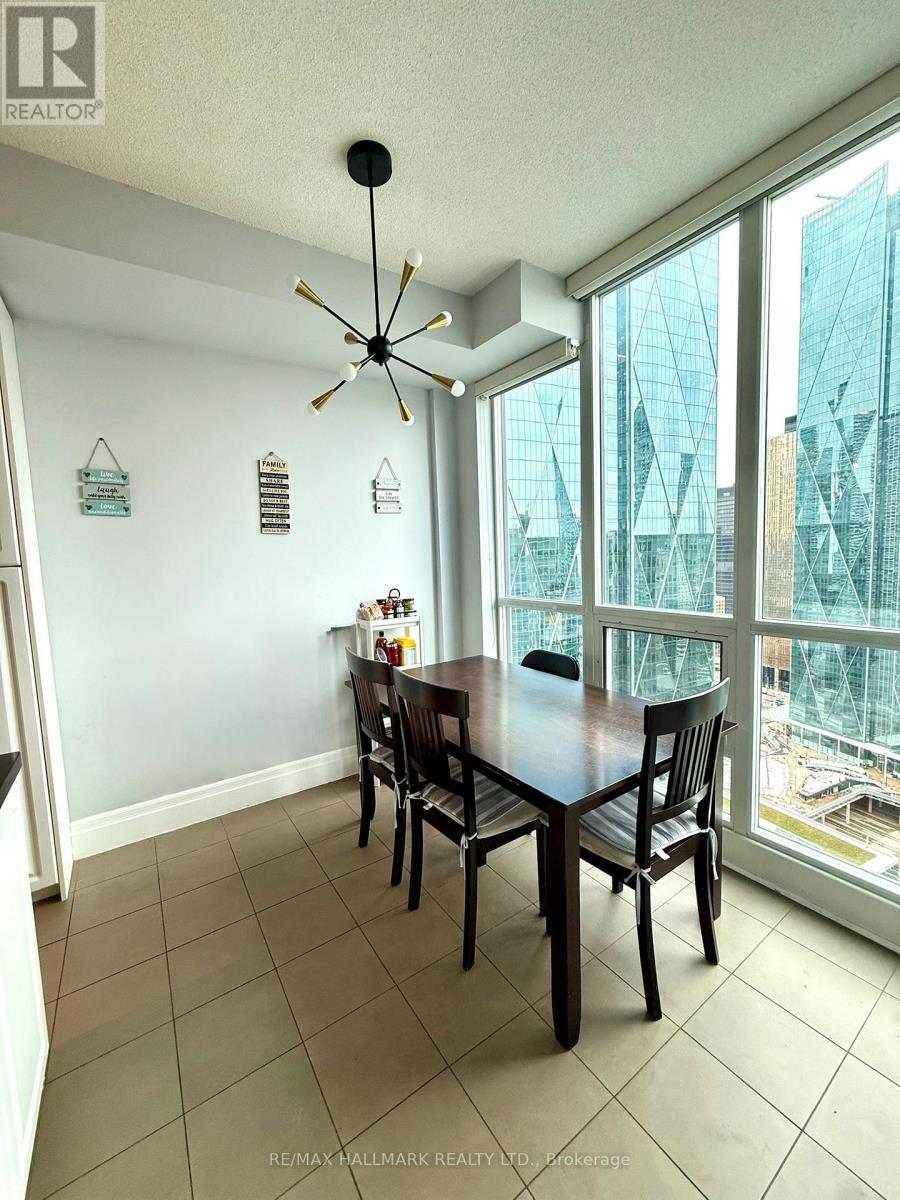 A dining room with a table and chairs and a ceiling fan.