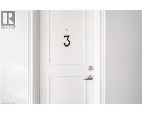 A white door with a silver handle and a number 3 on it.