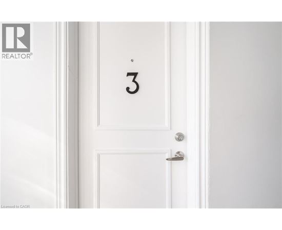 A white door with a silver handle and a number 3 on it.