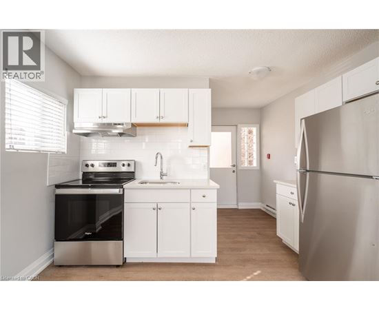A kitchen with white cabinets and stainless steel appliances.