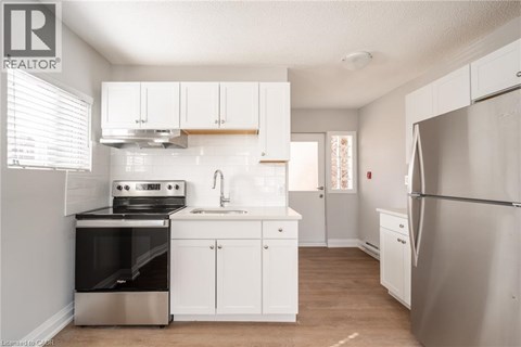 A kitchen with white cabinets and stainless steel appliances.